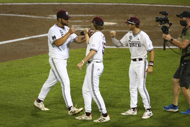 Mississippi State pitcher Preston Johnson, left, celebrates with teammates during the sixth inning against Vanderbilt in Game 2 of the NCAA College World Series baseball finals, Tuesday, June 29, 2021, in Omaha, Neb. (AP Photo/John Peterson)